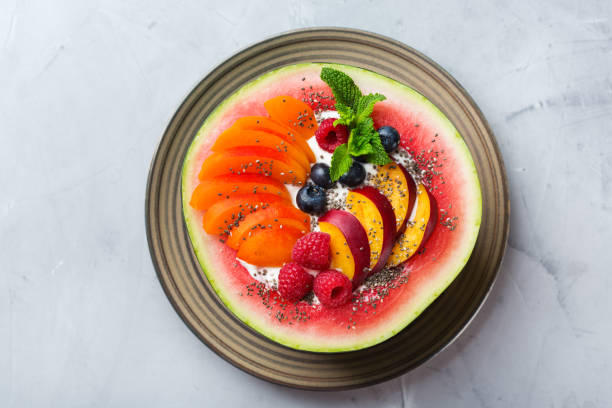 istock Healthy summer breakfast with fruit salad and yogurt in watermelon 1160623780
