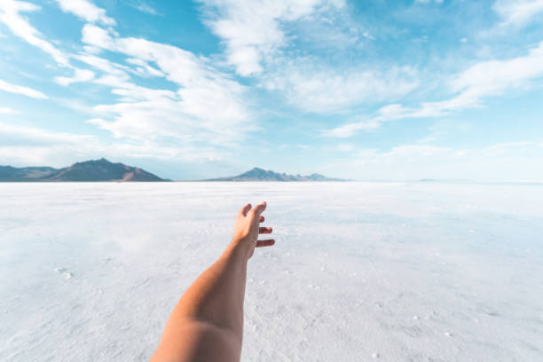 Personal perspective of a tourist visiting the Bonneville Salt Flats POV of a tourist experiencing the Bonneville Salt Flats in Utah on a beautiful summer day. personal perspective stock pictures, royalty-free photos & images