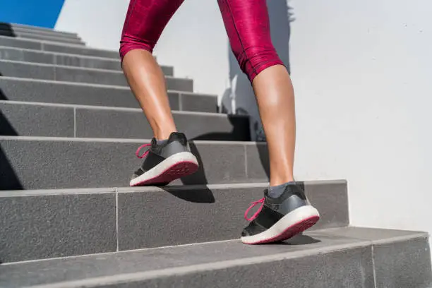 Photo of Running shoes runner woman walking up stairs