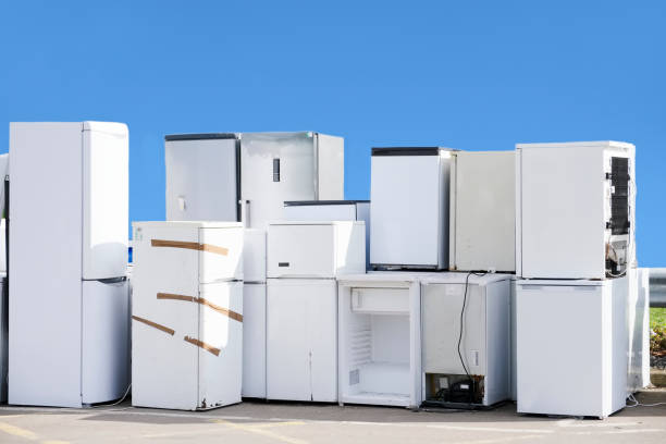istock Old fridges freezers refrigerant gas at refuse dump skip recycle stacked pile help environment reduce pollution white silver blue sky 1160628061