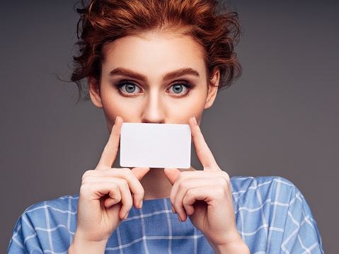 Young woman holding a business card