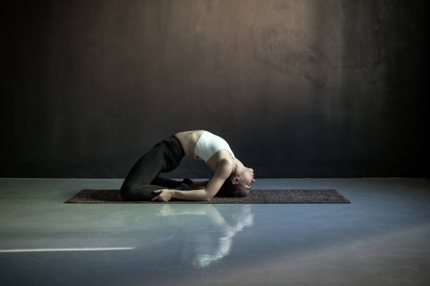 istock Woman practicing yoga, doing Pigeon exercise, Kapotasana pose. 1160629177