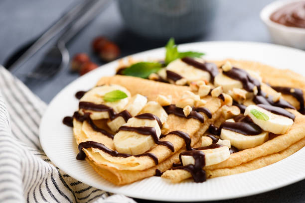 istock Banana and chocolate sauce on folded crepes 1160631115