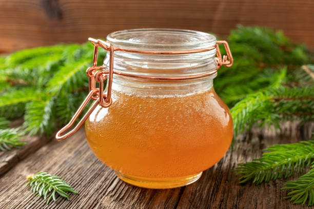 istock Homemade syrup against cough made from young spruce branches 1160631893