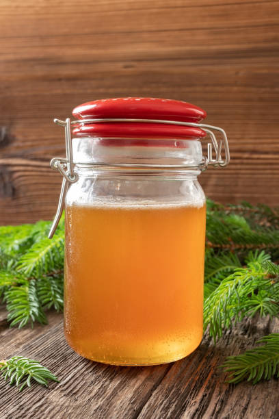 istock Homemade syrup against cough made from young spruce branches 1160631919