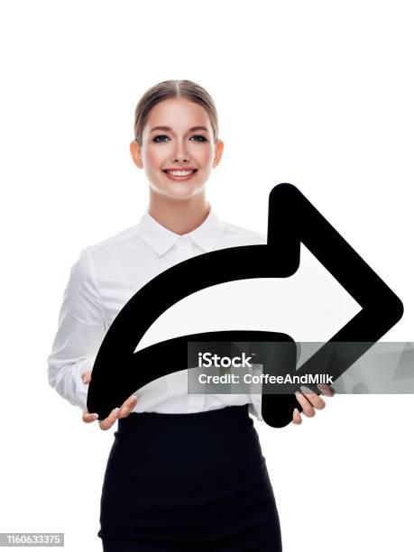 Attractive Girl Holding An Arrow Symbol Stock Photo - Download Image Now - Adult, Arrow Symbol, Beautiful People