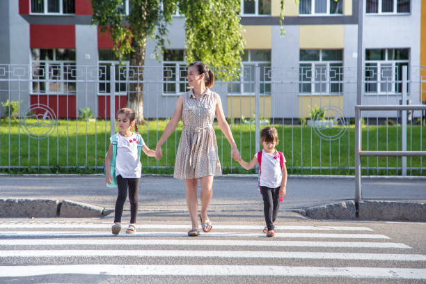 istock Back to school education concept with girl kids, elementary students, carrying backpacks going to class 1160634762