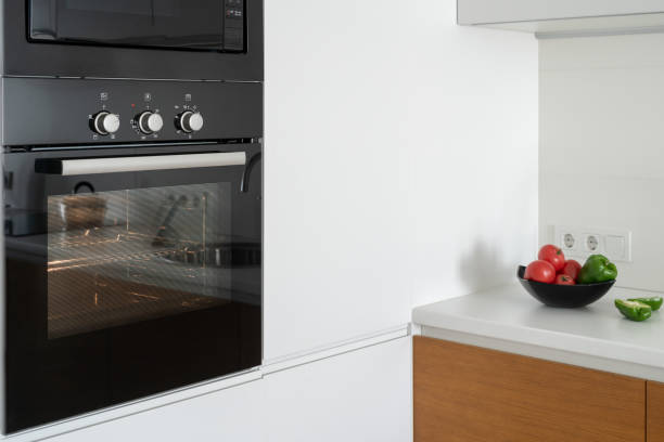 istock Modern built in oven with closed glass door on white kitchen 1160634798