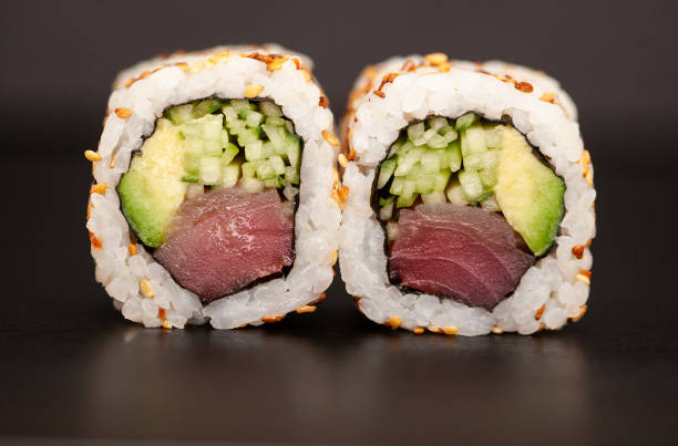 istock Japanese Sushi roll with salmon and cucumber on dark background. 1160634810
