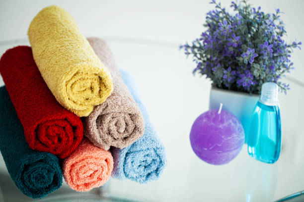 istock Colored towels on white table with copy space on bath room background 1160635364