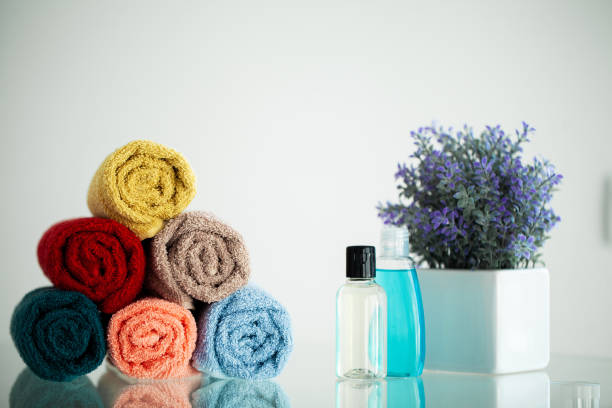 istock Colored towels on white table with copy space on bath room background 1160635406