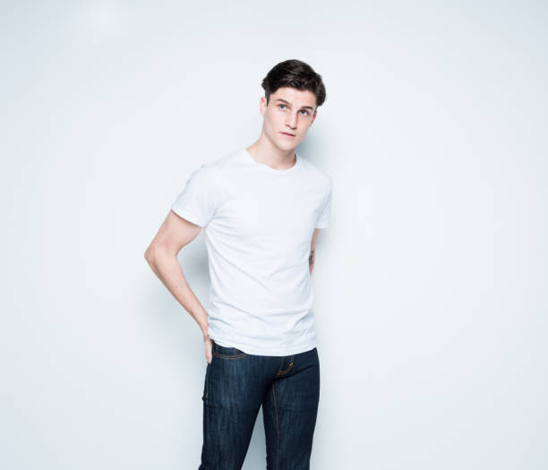 Handsome young man wearing a white t-shirt Handsome young man wearing a white t-shirt three quarter length stock pictures, royalty-free photos & images