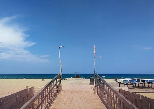 istock Wooden walkway on a golden sand beach 1160636281