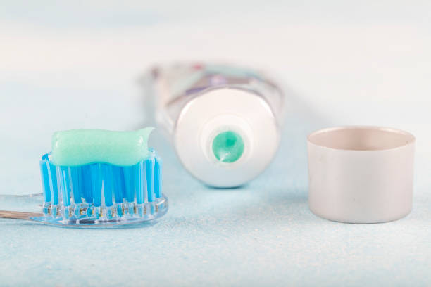 istock toothbrush on the table with toothpaste and toothpaste tube on blurred background. 1160636303