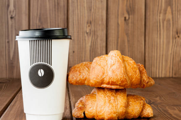 istock Paper coffee cup and croissants on wooden background, Copy space 1160636340