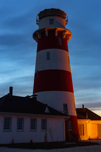 istock lighthouse on the sea at sunset 1160636437
