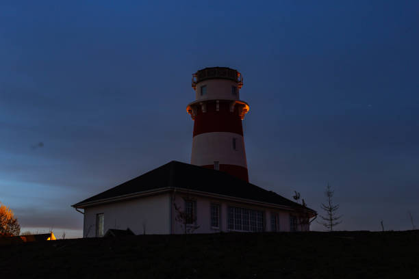 istock lighthouse on the sea at sunset 1160636438