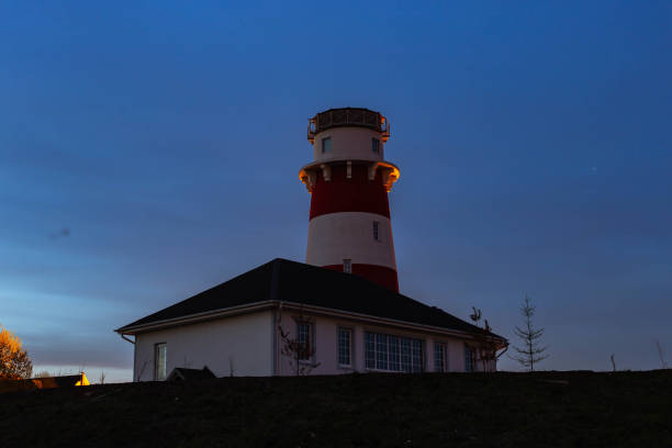 istock lighthouse on the sea at sunset 1160636447