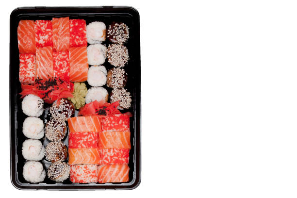 istock Big sushi set ib black plastic box on white background, top view close up, copy space 1160636657