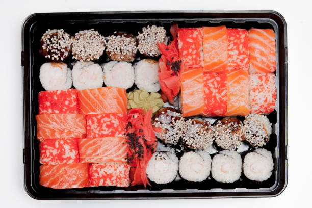 istock Big sushi set ib black plastic box on white background, top view close up, copy space 1160636663