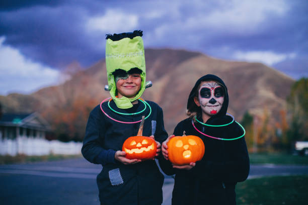 istock Young Children Holding Jack O' Lanterns for Halloween 1160637520