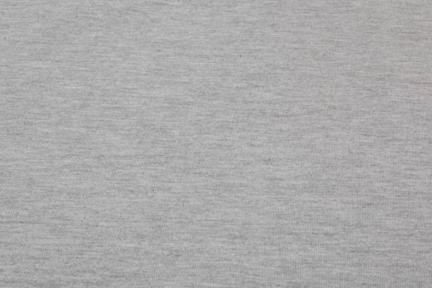 Real heather grey knitted fabric made of synthetic fibres textured background Real heather grey knitted fabric made of synthetic fibres textured background. heather grey stock pictures, royalty-free photos & images