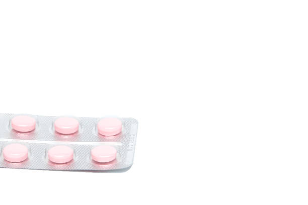 istock Pink tablet pills in blister , isolated on white background 1160637774