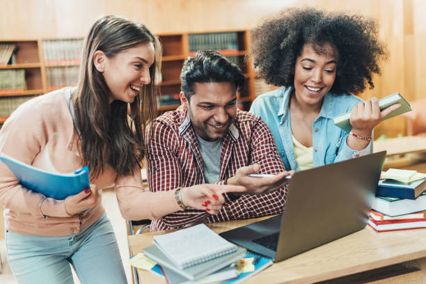 istock Multi-ethnic group of students working together in the library 1160639993