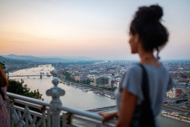 Woman looking at Budapest at sunset