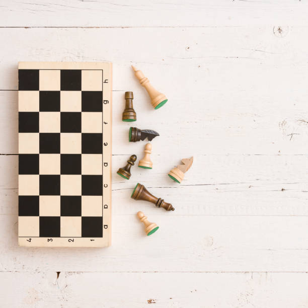 istock Wooden chess figures and chess board on white table background. Top view. 1160641339