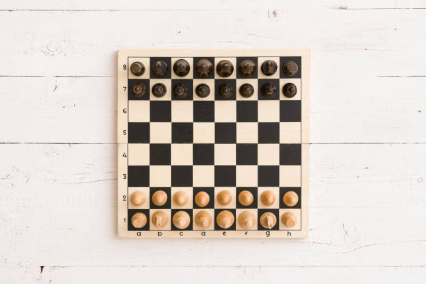 istock Above view on wooden chessboard with figures ready for the game. 1160641345
