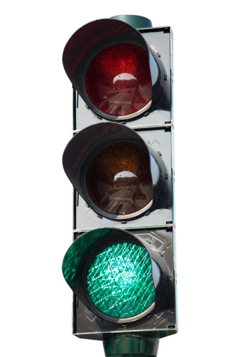 Traffic light, isolated on white, with the green light on. Clipping path included. Other traffic lights in: