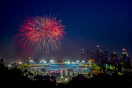 This is a photograph of Dodger's Stadium with downtown Los Angeles' skyline. This photo was taken on July 4, 2019.