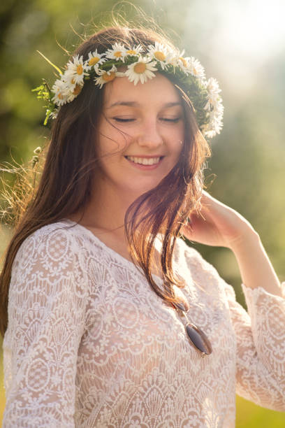 istock girl in camomile wreath 1160648230