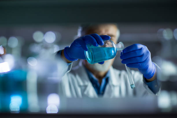 Senior male researcher carrying out scientific research in a lab Senior male researcher carrying out scientific research in a lab (shallow DOF; color toned image) chromatography stock pictures, royalty-free photos & images