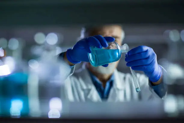 Photo of Senior male researcher carrying out scientific research in a lab