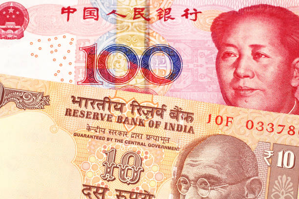 istock Ten Indian rupees with one hundred Chinese yuan 1160655046