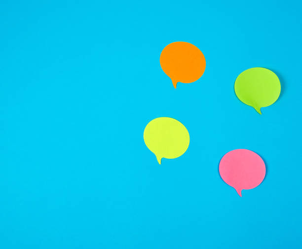 istock color paper stickers on a blue background, close up 1160655886