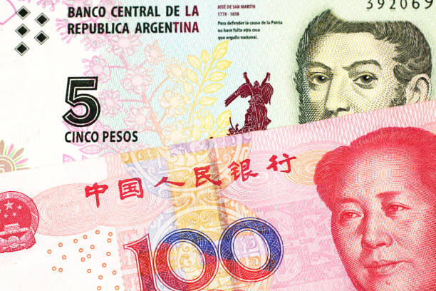 istock A peso note from Argentina, close up with a Chinese, yuan bill 1160656571