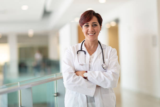 istock Smiling female physician standing in hospital corridor 1160659321