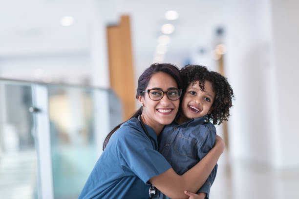 istock Female doctor hugging her toddler patient 1160659363