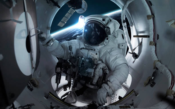 Astronaut at the international space station orbiting Earth planet. Elements of this image furnished by NASA