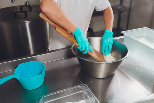 istock Traditional Cheese Making In A Small Company. Cheese Maker Hands Close-up Top View. 1160660557