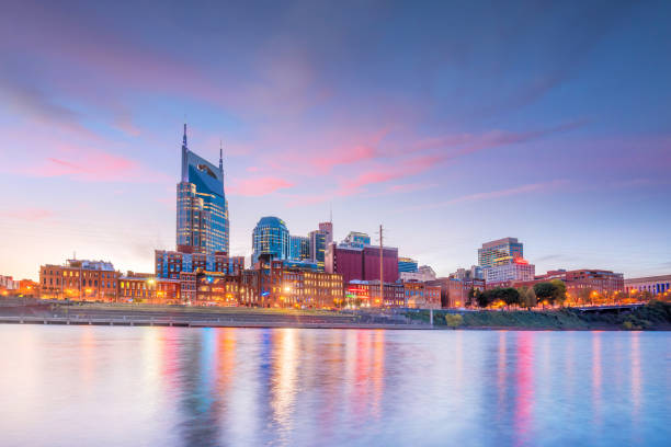 Nashville, Tennessee downtown skyline with Cumberland River in USA Nashville, Tennessee downtown skyline with Cumberland River in USA at sunset nashville stock pictures, royalty-free photos & images