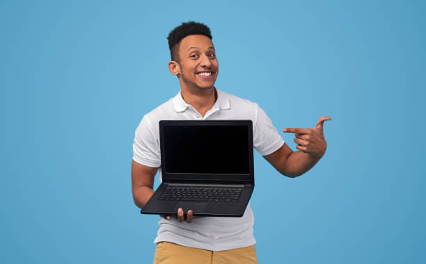 istock Smiling black man showing good offer on laptop 1160660816