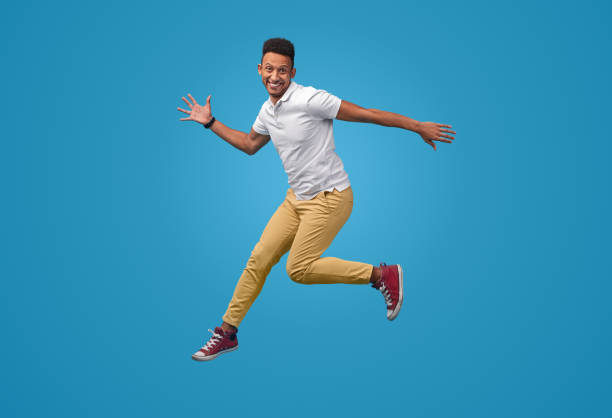 istock Funny black guy leaping up and smiling 1160660818