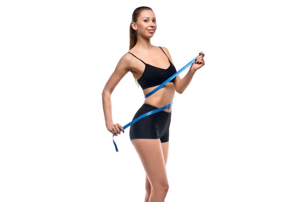 istock Smiling woman measuring waist 1160660841