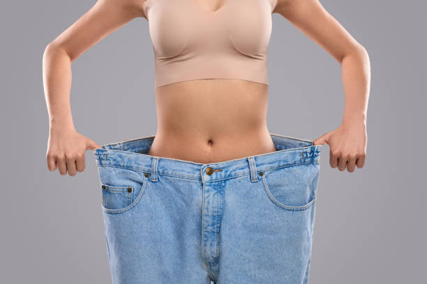 istock Crop slim lady in oversized jeans 1160660869
