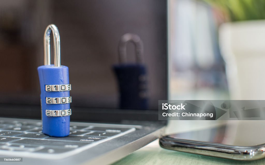Password protection and privacy cyber internet security for login office computer account and mobile application synchronization on smartphone via digital technology with passcode lock on laptop Accessibility Stock Photo
