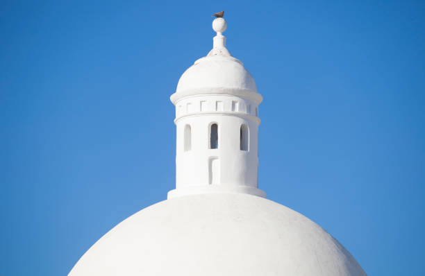 Whitewashed dome from Jerez de los Caballeros Alcazaba, Spain. Closeup over blue sky